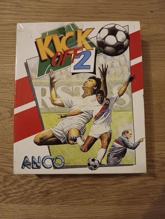 A real, slightly worn Kick Off 2 boxed copy photographed on a wooden table.